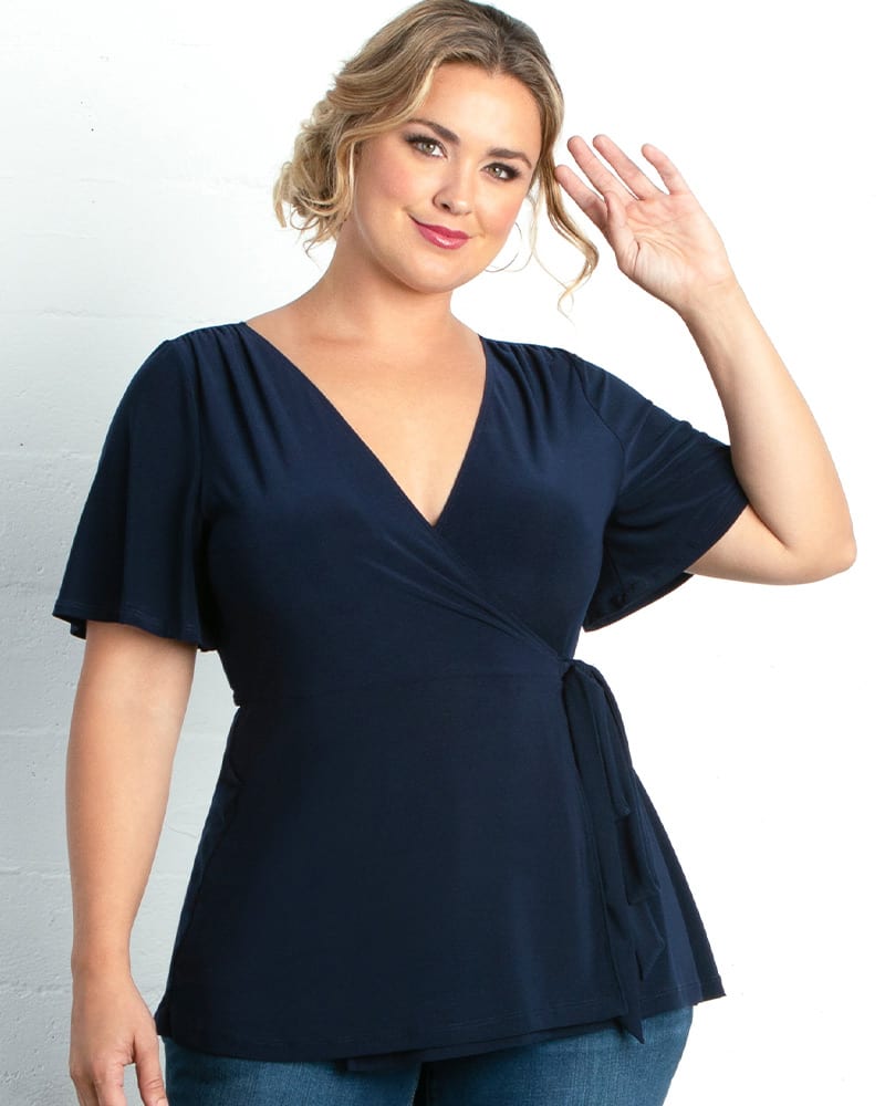 Front of a model wearing a size 0X Lacey Wrap Top in NOUVEAU NAVY by Kiyonna. | dia_product_style_image_id:227024